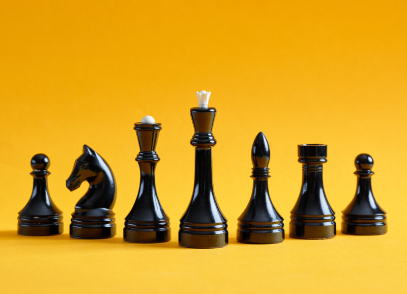 Black chess pieces with yellow background.